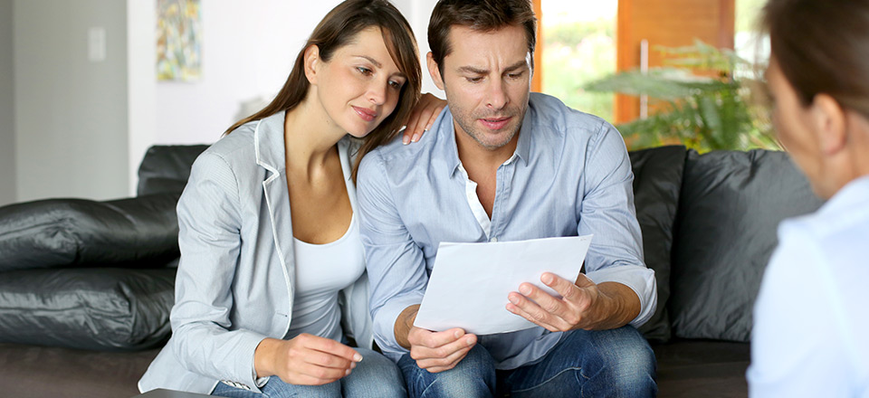 white maybe hispanic coupe reviewing documents with blurred out man